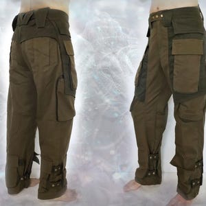 May include: A pair of olive green cargo pants with multiple pockets and adjustable straps at the bottom of the legs.