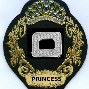May include: A black and gold embroidered patch with a crown, a diamond-shaped design, and the word "PRINCESS" in a gold banner.