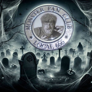 May include: A silver and black circular button with the text "Monster Fan Club Local 666" and a black and white image of a werewolf inside. The button is in front of a dark, spooky background with cobwebs and tombstones.