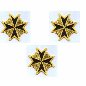 May include: Three gold-colored Maltese crosses with black centers and ornate detailing. The crosses are arranged on a white background. The design features eight points and a decorative border, suitable for emblems or decorative purposes.