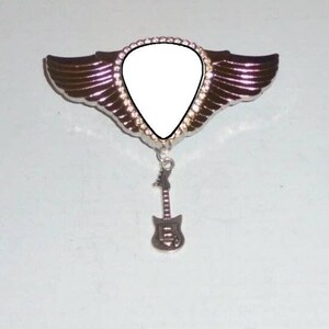 May include: Silver guitar pick with wings and a guitar charm. The pick is blank and ready to be personalized.