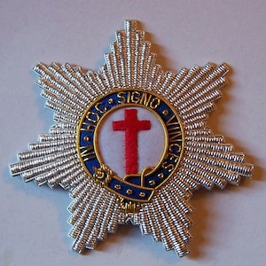 May include: A silver star-shaped badge with a red cross in a circle. The circle has the text "IN HOC SIGNO VINCES" around the edge.