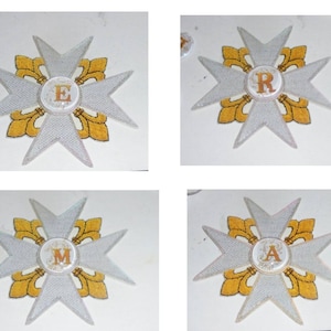 May include: Four white and gold embroidered patches with a fleur-de-lis design and a letter in the center. The letters are E, R, M, and A.