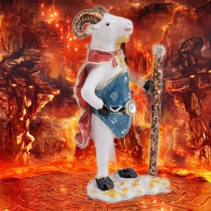 May include: A figurine of a white ram with golden horns, wearing a red cape and blue tunic, holding a staff. The figurine stands on a cloud-like base against a fiery, hellish background. The staff is brown with a golden top.