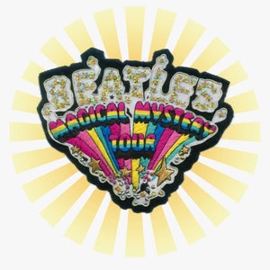 May include: A black felt patch with a rainbow design and the text "Beatles Magical Mystery Tour" in white and gold glitter.