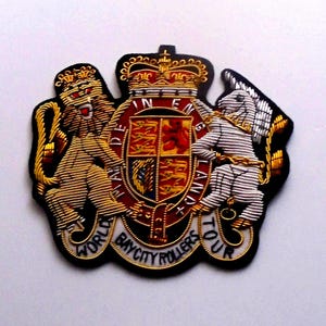 May include: A black embroidered patch with a gold and silver royal coat of arms, a lion and unicorn, and the text "World Bay City Rollers Tour".