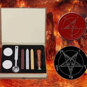 May include: A wooden box with a red velvet interior contains a set of wax seal tools. The tools include a wooden handle, a metal spoon, and four wax sticks. The box also includes two round wax seals with a pentagram design. One seal is red and the other is black.