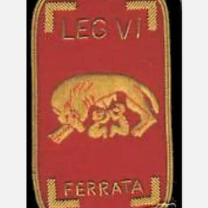 May include: A red and gold embroidered patch with the text "LEG VI FERRATA" and a depiction of a wolf.
