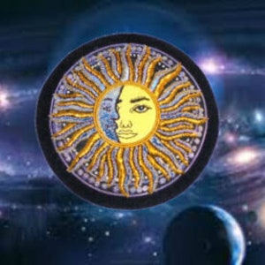 May include: A circular embroidered patch with a gold sun and a face in the center. The sun has a yellow face with a blue eye and a purple background. The patch is surrounded by a black circle with a purple border.