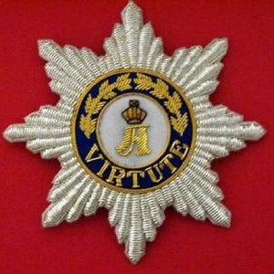 May include: A silver embroidered star with a blue and gold circular emblem in the center. The emblem features a crown, the letter "A", and the word "VIRTUTE".