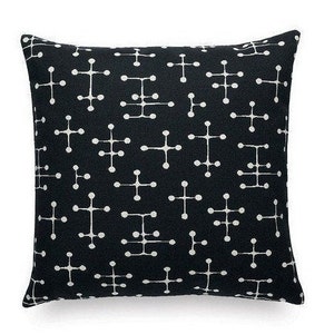 May include: Black and white geometric patterned throw pillow. The pattern features a repeating design of small white circles connected by lines.