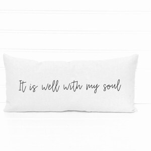 May include: White rectangular pillow with the handwritten text "It is well with my soul" in black script. The pillow is on a white surface with a white background.
