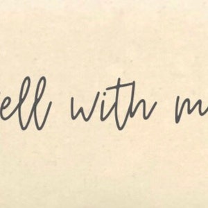 May include: A rectangular sign with the phrase "It is well with my soul" in elegant, dark gray cursive script. The text is centered on a cream-colored background, creating a simple yet impactful design. The sign's aesthetic is clean and suitable for various home decor styles.
