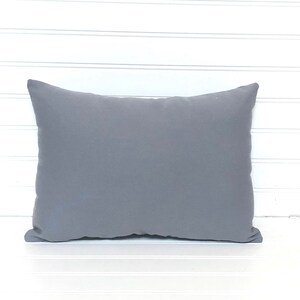 May include: A plain gray throw pillow with a soft, slightly textured fabric.