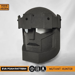 May include: A dark grey EVA foam Mutant Hunter mask, with a geometric design. The mask has a rectangular shape with a visor and a prominent brow. The text "EVA FOAM PATTERN" and "MUTANT HUNTER" are displayed on the bottom.