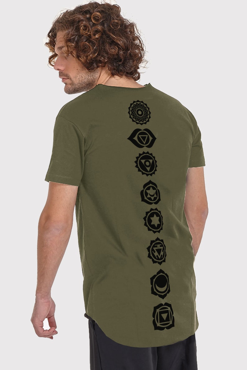 Pode incluir: Uma camiseta verde de manga comprida com uma fileira vertical de sete s&iacute;mbolos de chakras pretos impressos nas costas.