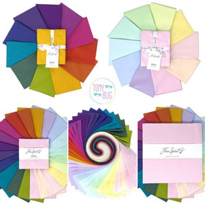 May include: A set of 20 fabric squares in a rainbow of colors, arranged in a circle. The fabric is a soft, light-weight cotton. The squares are labeled "Free Spirit" and "Tony Bug".