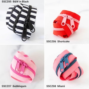 May include: Four coiled zippers labeled SSCZ05 B&W in Black with black and white stripes, SSCZ06 Shortcake in red with pink teeth, SSCZ07 Bubblegum in light pink with dark pink teeth, and SSCZ08 Miami in pink with dark blue teeth and sliders.