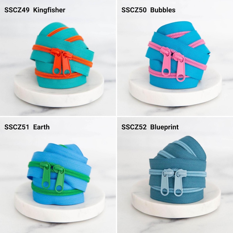 May include: Four coils of nylon zippers labeled SSCZ49 Kingfisher in teal and orange, SSCZ50 Bubbles in blue and pink, SSCZ51 Earth in light blue and green, and SSCZ52 Blueprint in dark blue, each featuring two matching zipper pulls.
