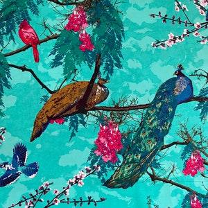 May include: A turquoise fabric with a repeating pattern of peacocks, cardinals, and blue jays perched on branches with pink blossoms. The background features a watercolor-like sky.