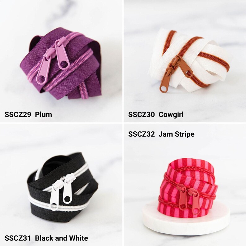 May include: Four coiled zippers: SSCZ29 Plum is purple with matching pulls, SSCZ30 Cowgirl is white with brown teeth and pulls, SSCZ31 Black and White features black tape with white teeth and pulls, and SSCZ32 Jam Stripe has red and pink stripes.