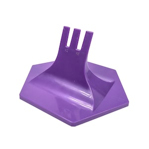 May include: A purple plastic tool with a hexagonal base and three prongs extending upwards. The prongs have the numbers "#2" and "#6" printed on them. The tool is designed for a specific purpose.