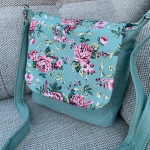 Floral print, messenger, crossbody bag in mint green needle cord, with adjustable shoulder strap and zip pocket, shoulder bag.