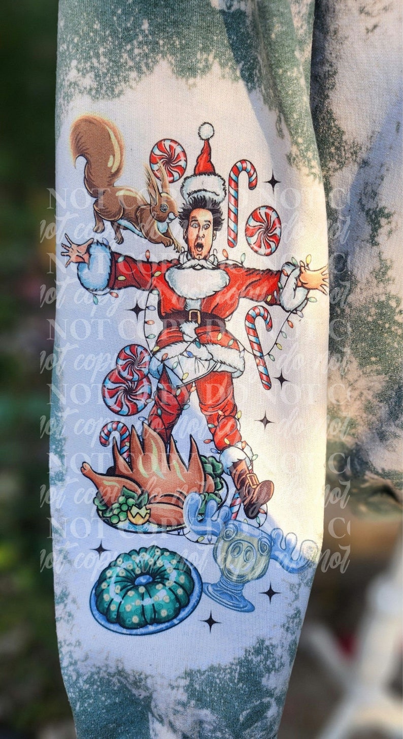 May include: A white and green sweatshirt featuring a cartoon illustration of a person dressed as Santa Claus, surrounded by Christmas-themed elements like candy canes, a squirrel, and a roasted turkey. The design has a distressed, bleached effect.