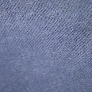 May include: Close-up of a blue fabric with a textured surface.