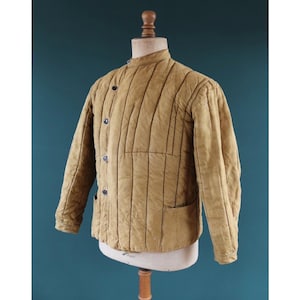 May include: A white ceramic mug with a black handle and the text "But First, Coffee" in a handwritten style. The mug is on a white surface. The mug is likely for hot beverages.