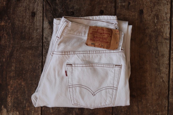 Vintage 1990s 90s Levis 501 Levi Strauss white red tab small e denim jeans button fly 32” x 31” made in USA mod