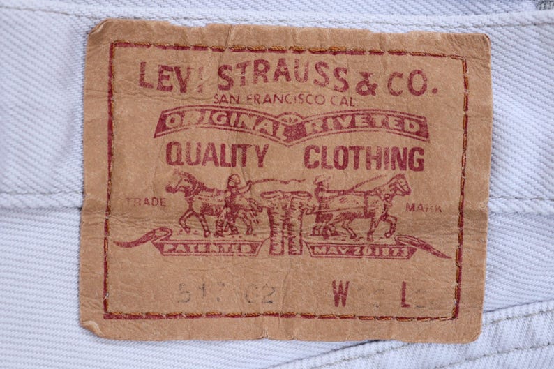 May include: A brown leather Levi Strauss & Co. patch with red text. The text reads "Original riveted quality clothing" and "Trade Mark Patented May 20 1873".