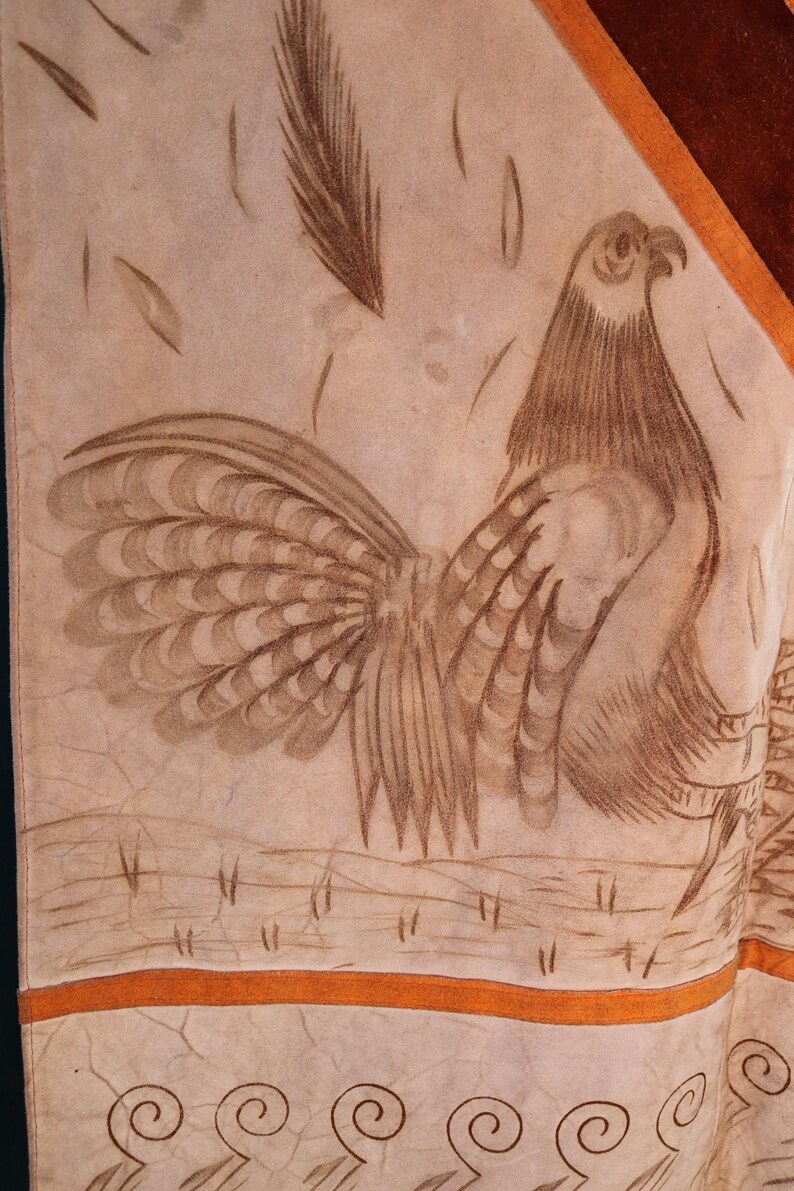 May include: A tan leather panel with a brown rooster design. The rooster is facing right and has a detailed tail. The panel has a brown border and a tan border with a repeating swirl design.