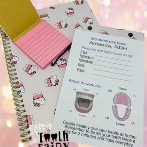 May include: A pink and white notepad with a Hello Kitty design. The notepad has a spiral binding and a pink sticky note attached to it. A white card with the text "NOTES FROM YOUR DENTAL HYGIENIST Amanda, RDH" is next to the notepad. The card has a list of dental products and techniques to try, as well as a diagram of the mouth with areas to work on. The card also includes the text "Create healthy oral care habits at home! Remember to brush your teeth twice a day for 2 minutes and floss everyday."