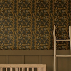 May include: A wooden cot with a white mattress and two pillows. The cot is in a room with brown wood panelling and a patterned wallpaper with gold and brown accents. A potted plant is in the corner of the room.