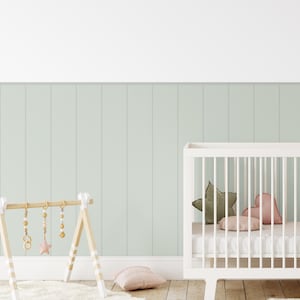 Soft green beadboard panel decals in a cozy nursery