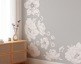 May include: A gray wall with a white floral design. The design features large and small flowers in a curved pattern.