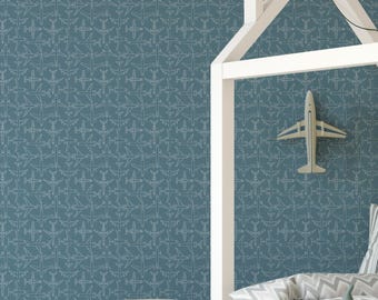 May include: Teal wallpaper featuring a repeating pattern of white airplane outlines. A white wooden house-shaped bed frame is visible, along with a decorative airplane and a woven basket. The theme is aviation and children's decor.
