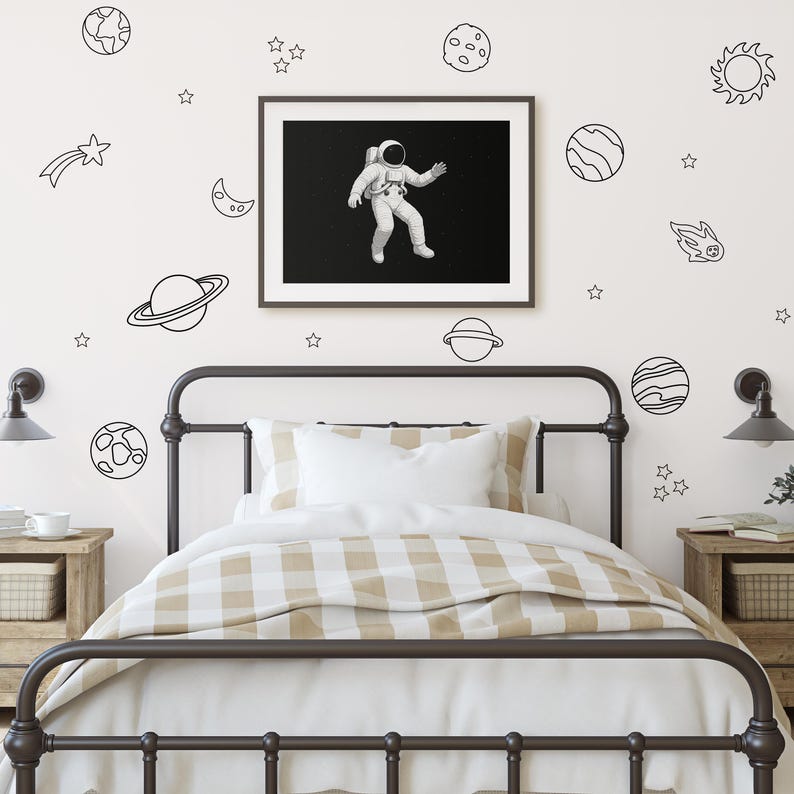 Neutral-toned bedroom featuring Simple Space Decals above a framed astronaut print