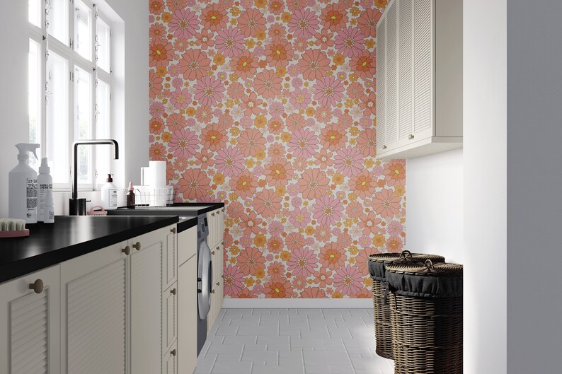 Modern laundry room design featuring retro floral removable self-adhesive wallpaper, creating a lively and cheerful backdrop against the contrast of white cabinetry and dark countertops.