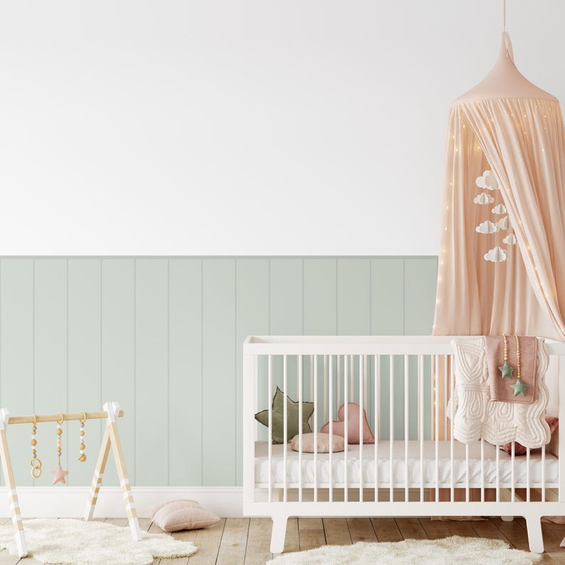 Soft green beadboard panel decals in a cozy nursery
