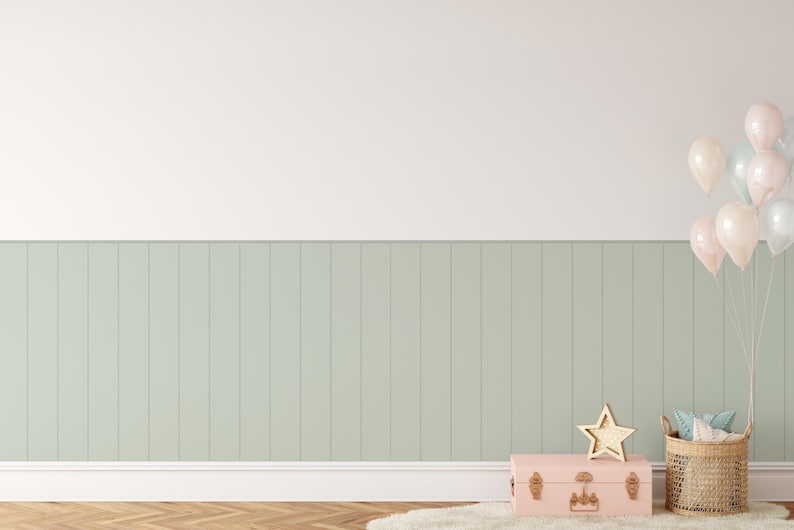 May include: A light green wood panel wall with a pink vintage suitcase, a wicker basket with fabric inside, and a gold star decoration. A cluster of pastel pink, white, and light blue balloons are tied together and floating in the upper right corner of the image.