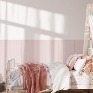 May include: A white bed frame with a pink and white bedding set. The bed is decorated with a white canopy and a pink throw blanket. There is a wooden dresser with drawers next to the bed.