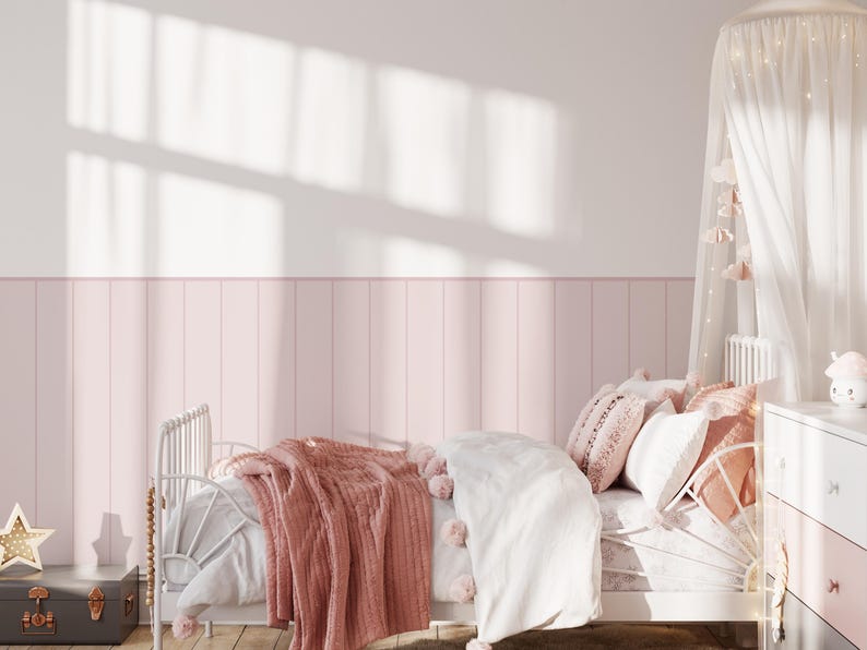 May include: A white bed frame with a pink and white bedding set. The bed is decorated with a white canopy and a pink throw blanket. There is a wooden dresser with drawers next to the bed.