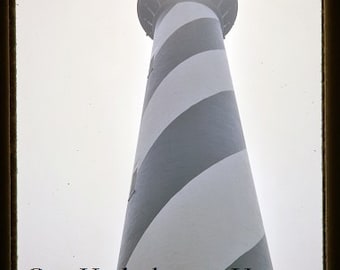 May include: A black and white striped lighthouse with a bright sun shining down on it. The text "Our Kodachrome Years" is visible at the bottom of the image.