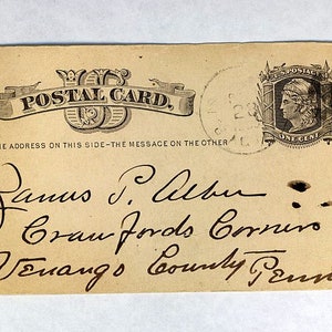 May include: A vintage postcard with the text "U.S. POSTAL CARD" and "WRITE THE ADDRESS ON THIS SIDE-THE MESSAGE ON THE OTHER" printed on it. The postcard is addressed to "James J. Albur, Crau Fords Corners, Venang's County Penn."
