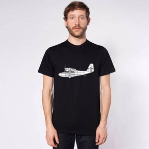 May include: A black t-shirt with a white outline of a seaplane on the front.