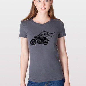 May include: A charcoal grey t-shirt with a black graphic of an octopus riding a motorcycle.