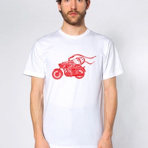 May include: White t-shirt with a red graphic of an octopus riding a motorcycle.