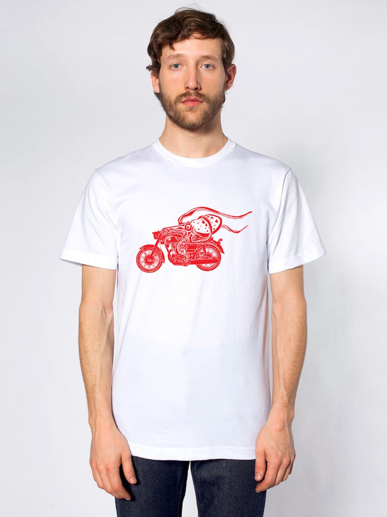 May include: White t-shirt with a red graphic of an octopus riding a motorcycle.